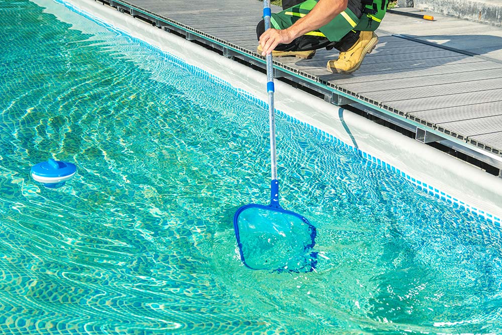 cleaning-swimming-pool-with-skimmer-net-resize.jpg